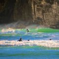 Surfing at the famous beach of Piha near Auckland